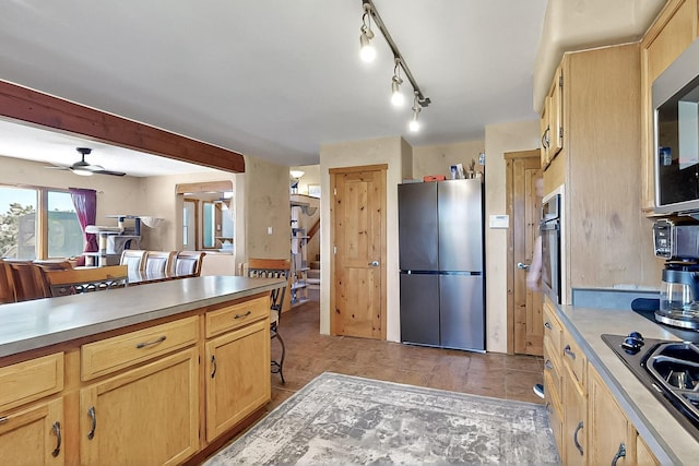 26 Apache Creek Rd, Santa Fe, NM 87505 - kitchen with appliances with stainless steel finishes, light brown cabinetry, light countertops, and ceiling fan