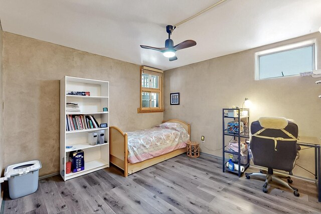 26 Apache Creek Rd, Santa Fe, NM 87505 - bedroom featuring wood finished floors and multiple windows