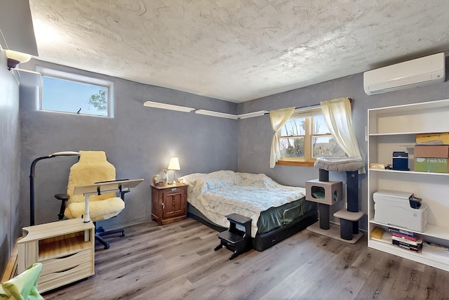 26 Apache Creek Rd, Santa Fe, NM 87505 - bedroom featuring a wall mounted air conditioner and wood finished floors
