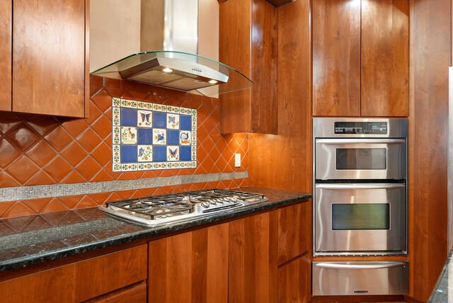 28 Canon Escondido, Sandia Park, NM 87047 - kitchen featuring appliances with stainless steel finishes, a warming drawer, range hood, and brown cabinets