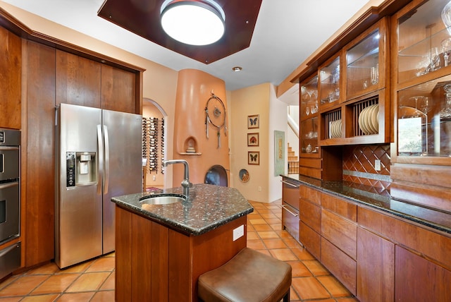 28 Canon Escondido, Sandia Park, NM 87047 - kitchen featuring stainless steel refrigerator with ice dispenser, a sink, light tile patterned floors, and dark stone counters