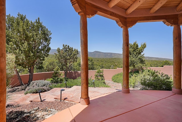 28 Canon Escondido, Sandia Park, NM 87047 - view of patio / terrace with a mountain view and a fenced backyard