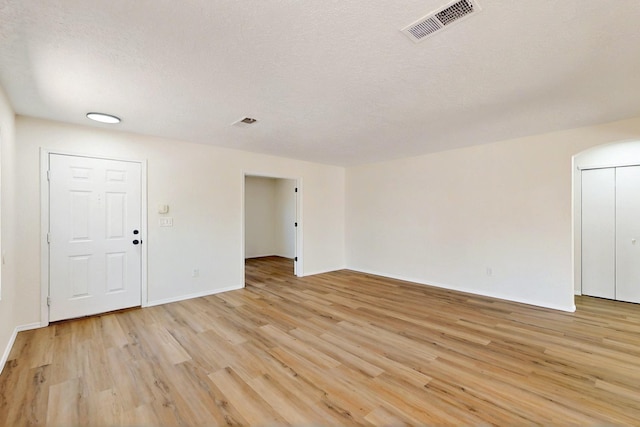 9927 Silverton Dr NW, Albuquerque, NM 87114 - empty room featuring light wood-style floors, a textured ceiling, and baseboards