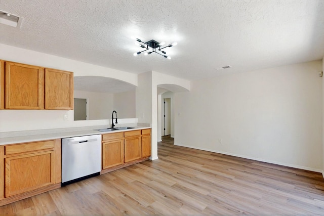 9927 Silverton Dr NW, Albuquerque, NM 87114 - kitchen with dishwasher, a sink, arched walkways, light wood-type flooring, and light countertops
