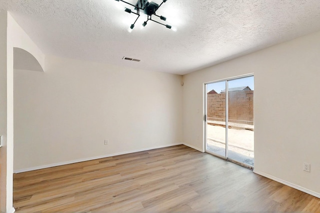 9927 Silverton Dr NW, Albuquerque, NM 87114 - unfurnished room with wood finished floors, a textured ceiling, and baseboards