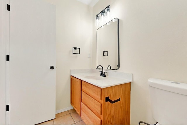 9927 Silverton Dr NW, Albuquerque, NM 87114 - bathroom with vanity, toilet, tile patterned floors, and baseboards