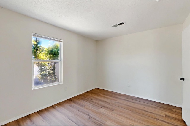 9927 Silverton Dr NW, Albuquerque, NM 87114 - empty room featuring wood finished floors, baseboards, and a textured ceiling