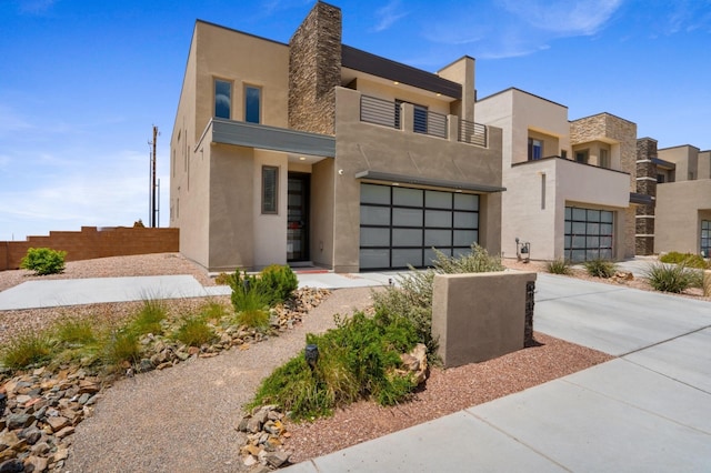 801 Horned Owl Dr NE, Albuquerque, NM 87122 - modern home featuring concrete driveway, stucco siding, and an attached garage