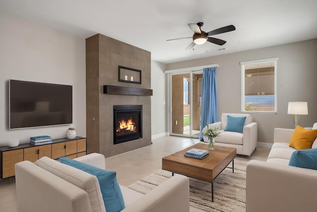 801 Horned Owl Dr NE, Albuquerque, NM 87122 - living room featuring a ceiling fan, a fireplace, and baseboards