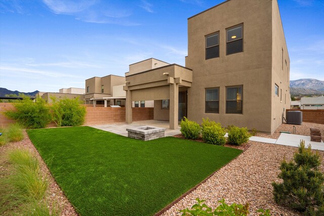 801 Horned Owl Dr NE, Albuquerque, NM 87122 - rear view of house with a patio, cooling unit, stucco siding, and a mountain view
