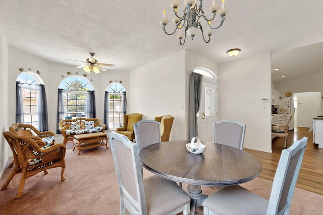 10320 Durham St NW, Albuquerque, NM 87114 - dining space with a textured ceiling, ceiling fan, a chandelier, and light wood finished floors