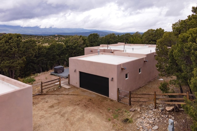 13 Asher Ln, Tijeras, NM 87059 - view of home's exterior with fence, stucco siding, and a garage