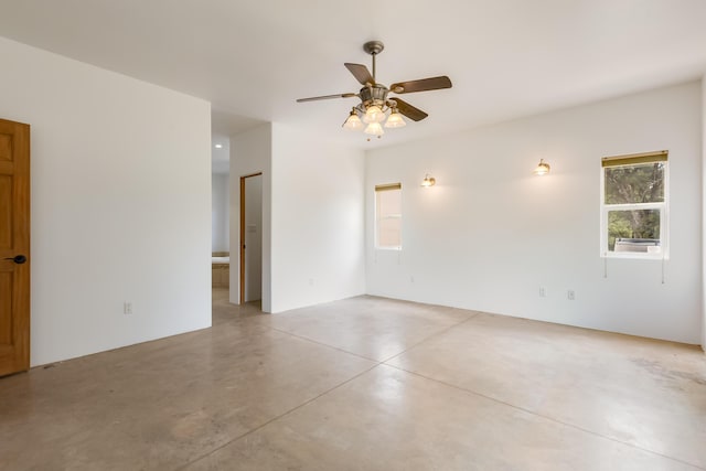 13 Asher Ln, Tijeras, NM 87059 - empty room featuring plenty of natural light, finished concrete flooring, and a ceiling fan