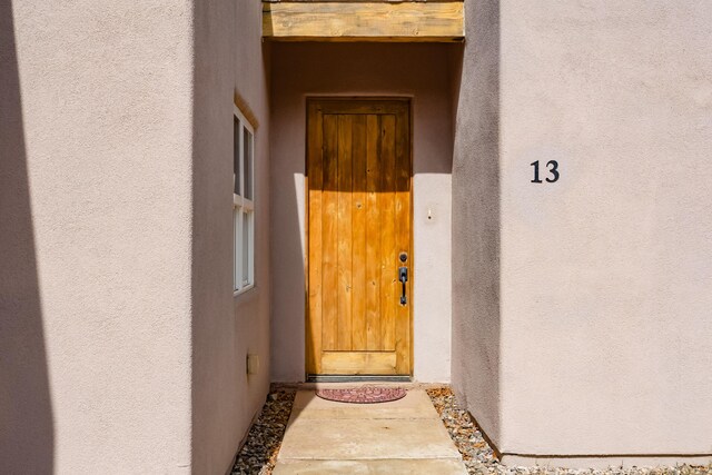 13 Asher Ln, Tijeras, NM 87059 - doorway to property featuring stucco siding