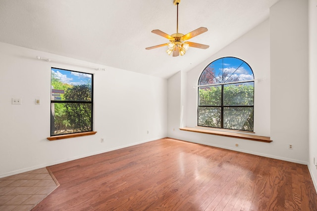1905 Gomez Dr SW, Los Lunas, NM 87031 - empty room with wood finished floors, ceiling fan, baseboards, and high vaulted ceiling