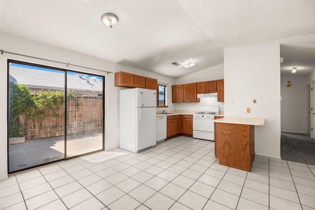 1905 Gomez Dr SW, Los Lunas, NM 87031 - kitchen featuring white appliances, light countertops, brown cabinets, a peninsula, and vaulted ceiling