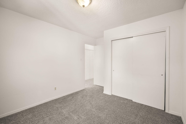 1905 Gomez Dr SW, Los Lunas, NM 87031 - unfurnished bedroom with carpet flooring, a closet, and a textured ceiling