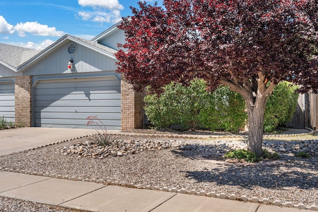1905 Gomez Dr SW, Los Lunas, NM 87031 - view of front of property featuring a garage, driveway, and brick siding