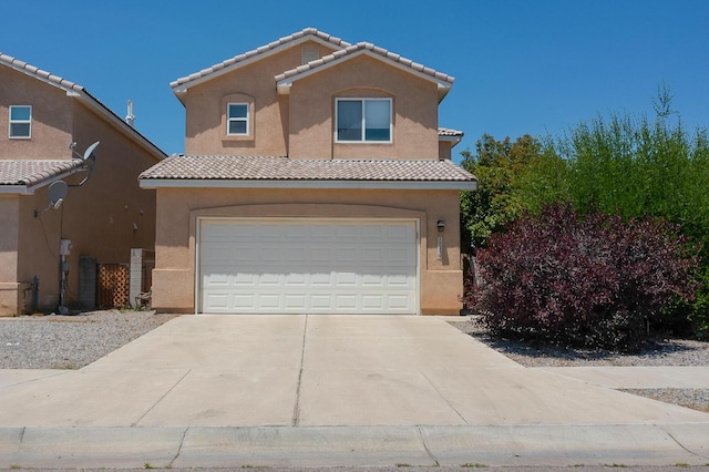 1723 Avenida Real, Albuquerque, NM 87105 - view of front of property with a garage, stucco siding, concrete driveway, and a tile roof