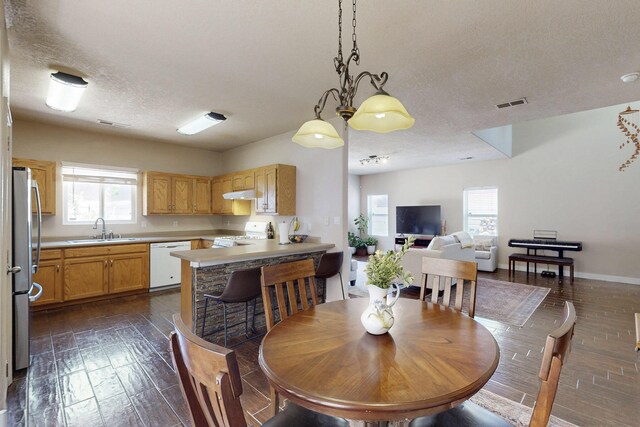 1723 Avenida Real, Albuquerque, NM 87105 - dining area featuring dark wood-style floors and a textured ceiling