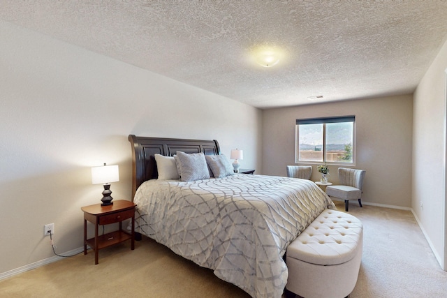 1723 Avenida Real, Albuquerque, NM 87105 - bedroom featuring light carpet, a textured ceiling, and baseboards