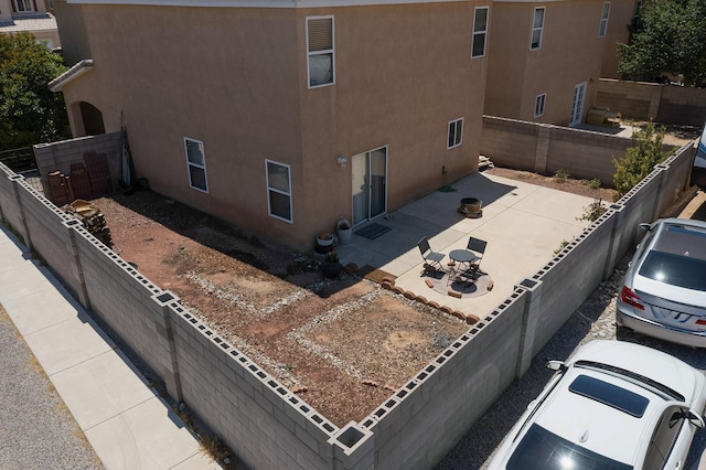 1723 Avenida Real, Albuquerque, NM 87105 - view of property exterior featuring stucco siding, a patio, and a fenced backyard
