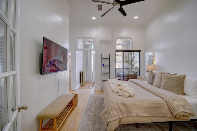 223 14th St NW, Albuquerque, NM 87104 - bedroom with light wood-style floors, radiator, and recessed lighting