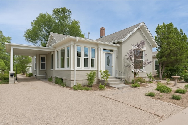 223 14th St NW, Albuquerque, NM 87104 - view of front facade featuring roof with shingles, driveway, a carport, and a chimney
