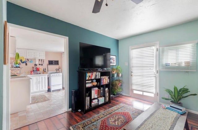 223 14th St NW, Albuquerque, NM 87104 - living area with ceiling fan, wood finished floors, and baseboards