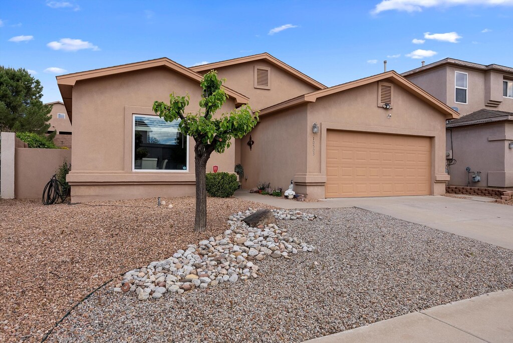 10503 Bilboa St NW, Albuquerque, NM 87114 - view of front of house featuring stucco siding, concrete driveway, and an attached garage