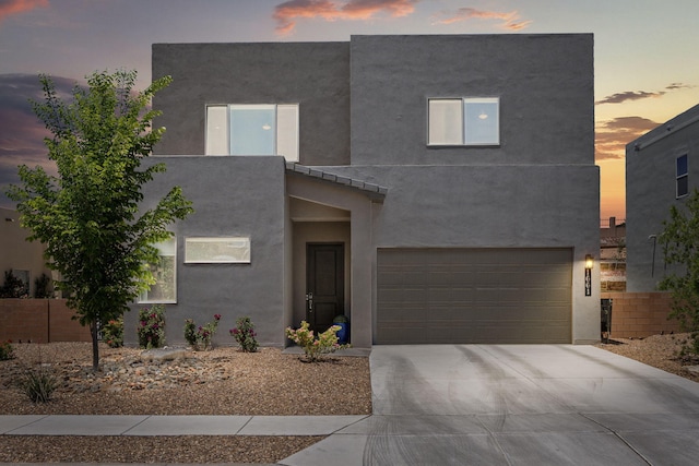 1661 Camino Culiacan, Los Lunas, NM 87031 - view of front of house with driveway, an attached garage, and stucco siding