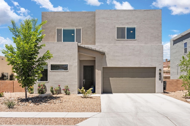 1661 Camino Culiacan, Los Lunas, NM 87031 - view of front of home with stucco siding, an attached garage, and driveway