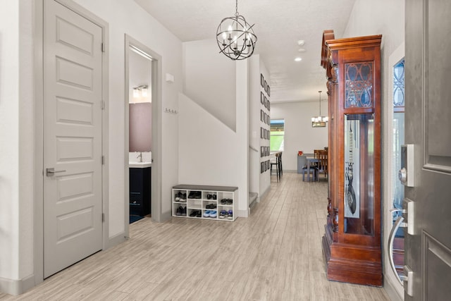 1661 Camino Culiacan, Los Lunas, NM 87031 - entrance foyer featuring a chandelier, light wood finished floors, and baseboards
