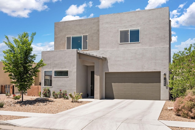 1661 Camino Culiacan, Los Lunas, NM 87031 - view of front of house with stucco siding, a garage, and concrete driveway