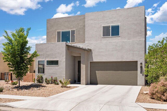 1661 Camino Culiacan, Los Lunas, NM 87031 - view of front of house featuring stucco siding, a garage, and concrete driveway