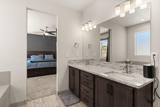 1661 Camino Culiacan, Los Lunas, NM 87031 - full bath featuring wood finished floors, ceiling fan, ensuite bathroom, double vanity, and tasteful backsplash
