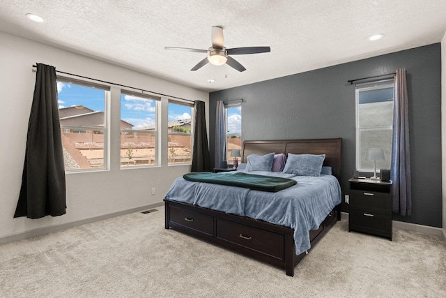 1661 Camino Culiacan, Los Lunas, NM 87031 - bedroom featuring a textured ceiling, light colored carpet, baseboards, and ceiling fan