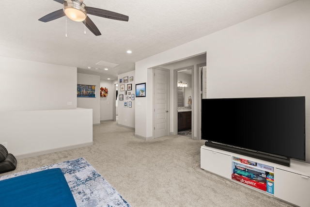 1661 Camino Culiacan, Los Lunas, NM 87031 - unfurnished living room featuring light colored carpet, a ceiling fan, recessed lighting, a textured ceiling, and baseboards