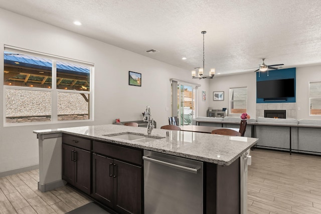 1661 Camino Culiacan, Los Lunas, NM 87031 - kitchen with dishwasher, a sink, a textured ceiling, light wood-type flooring, and ceiling fan