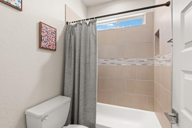 1661 Camino Culiacan, Los Lunas, NM 87031 - bathroom featuring a textured wall, toilet, and shower / bath combo