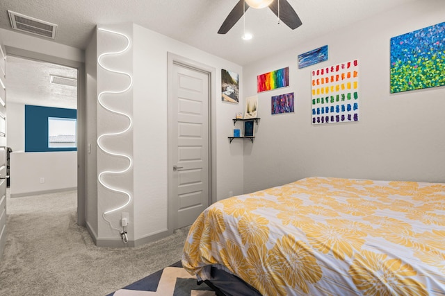 1661 Camino Culiacan, Los Lunas, NM 87031 - bedroom with carpet, baseboards, a textured ceiling, ceiling fan, and a closet