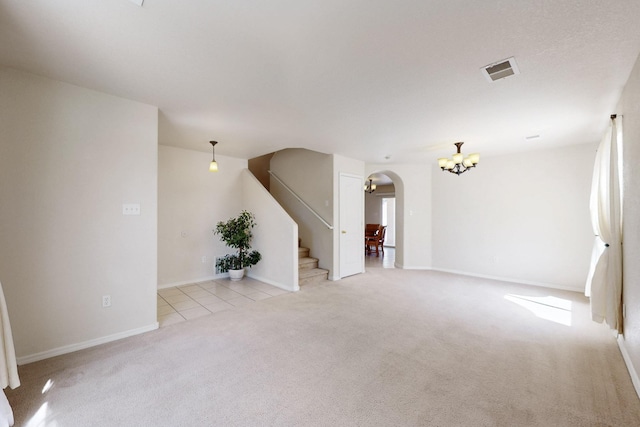 525 Peaceful Meadows Dr NE, Rio Rancho, NM 87144 - unfurnished living room featuring arched walkways, a chandelier, carpet floors, stairway, and baseboards