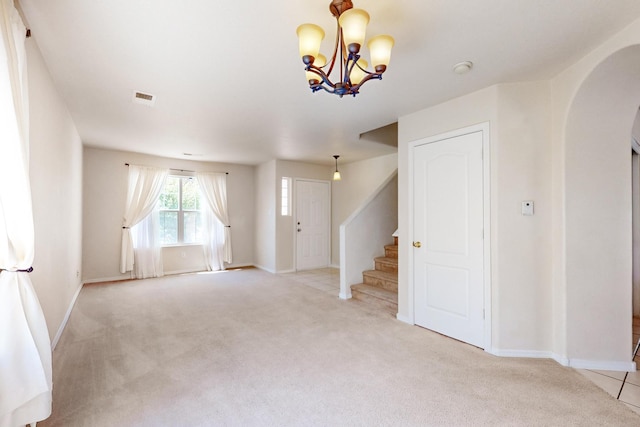 525 Peaceful Meadows Dr NE, Rio Rancho, NM 87144 - unfurnished living room with arched walkways, light colored carpet, stairs, and baseboards