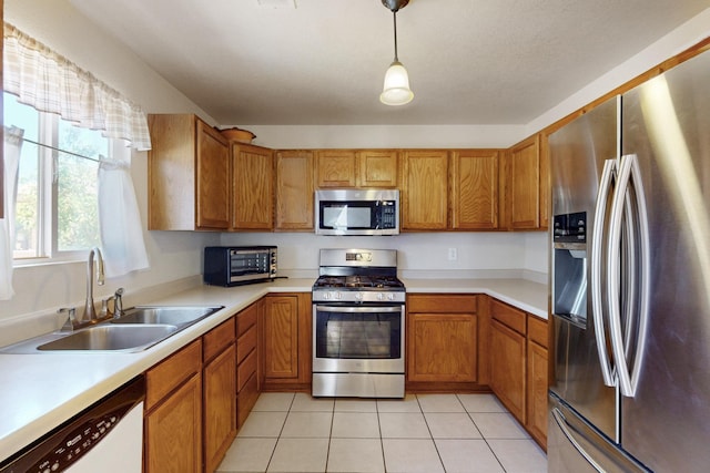 525 Peaceful Meadows Dr NE, Rio Rancho, NM 87144 - kitchen featuring appliances with stainless steel finishes, a sink, brown cabinets, and light countertops
