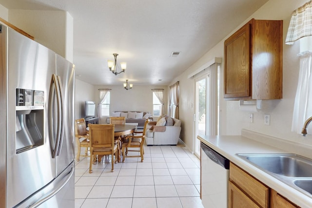 525 Peaceful Meadows Dr NE, Rio Rancho, NM 87144 - kitchen featuring stainless steel refrigerator with ice dispenser, dishwashing machine, a sink, light countertops, and open floor plan