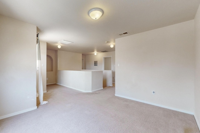 525 Peaceful Meadows Dr NE, Rio Rancho, NM 87144 - spare room with light carpet, baseboards, and arched walkways