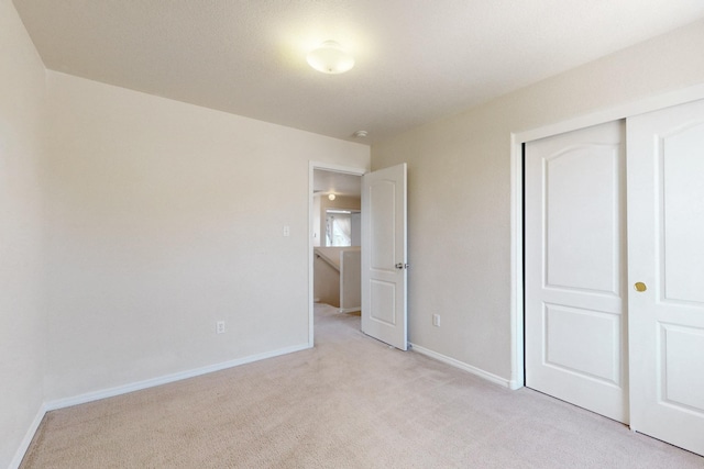 525 Peaceful Meadows Dr NE, Rio Rancho, NM 87144 - unfurnished bedroom with light colored carpet, a closet, and baseboards
