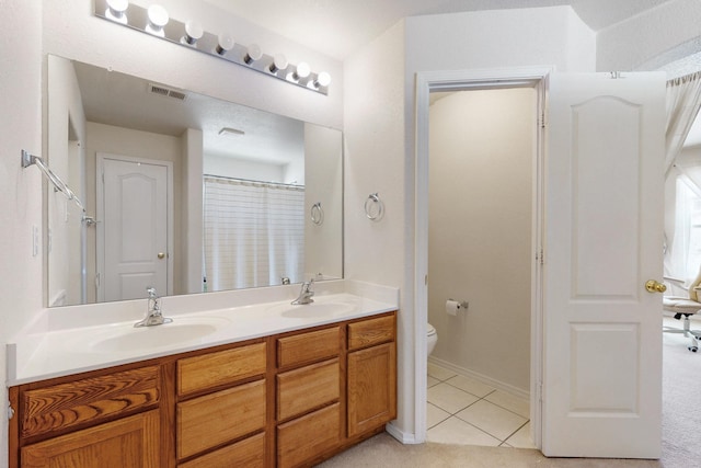 525 Peaceful Meadows Dr NE, Rio Rancho, NM 87144 - bathroom featuring double vanity, toilet, tile patterned floors, and baseboards