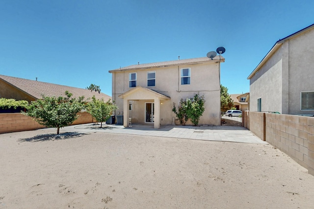 525 Peaceful Meadows Dr NE, Rio Rancho, NM 87144 - back of property with a fenced backyard, stucco siding, a patio area, and central AC unit