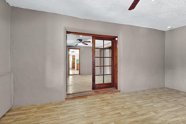 1237 Gabaldon Rd, Belen, NM 87002 - empty room with ceiling fan, wood finished floors, and a textured ceiling